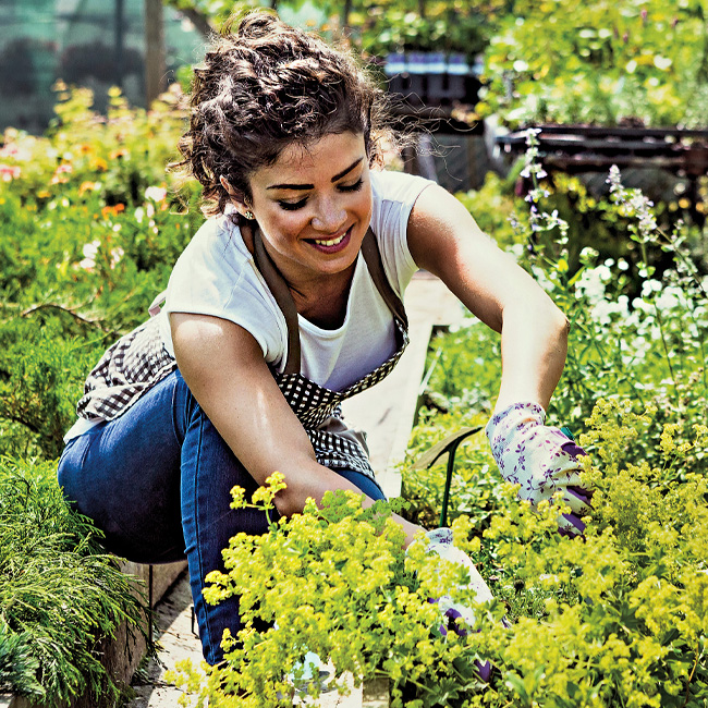 A woman enjoys her garden